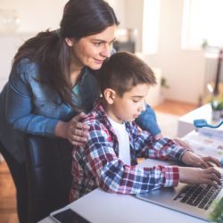 A picture of a mother homeschooling her son using the HUE HD Pro camera